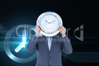 Business man holding a clock against background with clock