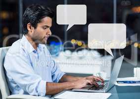 Man on laptop working late with empty chat bubbles