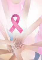 Pink ribbon with breast cancer awareness women putting hands together