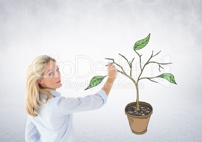 Woman holding pen and Drawing of Plant branches and leaves on wall