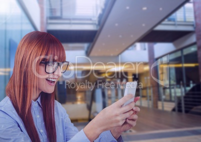 Woman holding phone in building