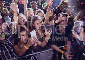 People having fun and making photos at a concert with 3D confetti