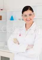Happy doctor woman with breast cancer awareness ribbon
