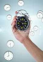 Business man holding a clock against background with clocks