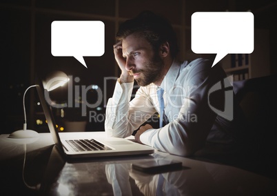 Man working on laptop with empty chat bubbles