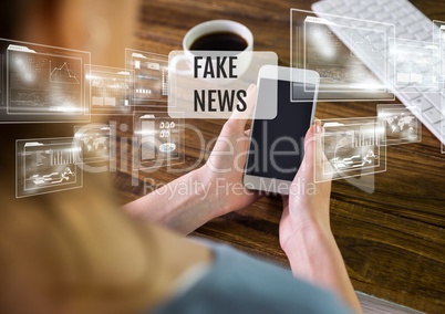 Holding phone with Fake news text and interface