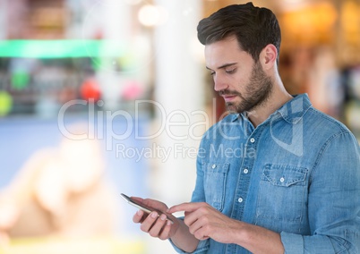 Man holding phone in mall shopping centre