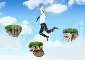 Businessman jumping between steps of floating rock platforms in sky