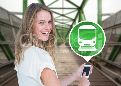 Woman holding phone with train icon on railway track