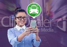 Woman holding phone with car icon in city