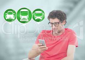 Man holding phone with transport icons in station