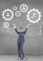 Business woman interacting with people in cogs graphics against grey background