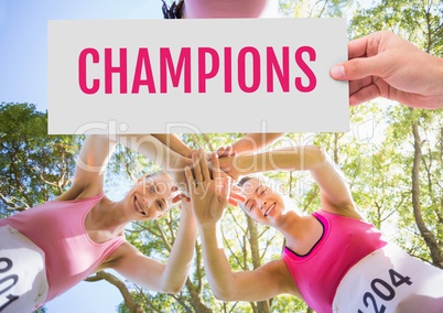 Champions Text and Hand holding card with pink breast cancer awareness women marathon run