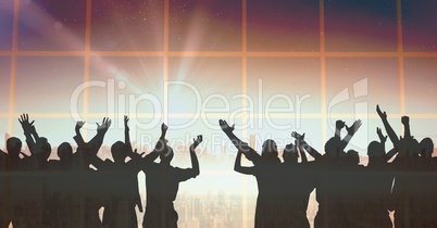 Silhouette of group of people celebrating at party with transition background and shining light