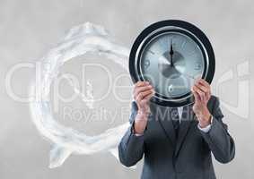 Business man holding a clock against background with clock