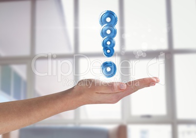 Hand holding exclamation mark made of cogs