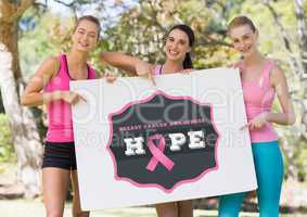 Hope text and pink breast cancer awareness women holding card