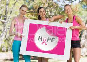 Hope text and pink breast cancer awareness women holding card