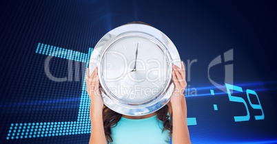 Woman holding a clock against background with clock