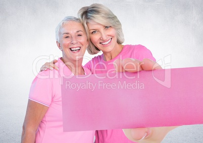 Hand holding card with pink breast cancer awareness women