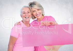 Hand holding card with pink breast cancer awareness women