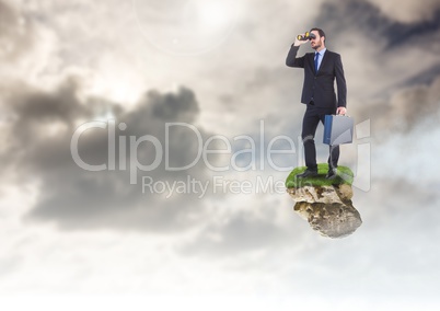 Businessman with binoculars on floating rock platform in sky