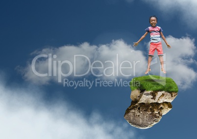 Young boy on floating rock platform  in sky jumping