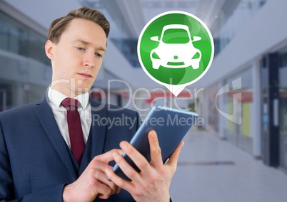 Man holding tablet with car icon