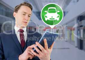 Man holding tablet with car icon