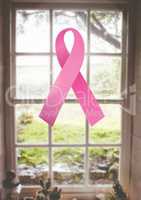 pink ribbon for breast cancer awareness over bright window background