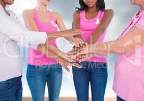 Breast cancer women  putting hands together with sky clouds background