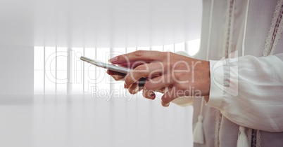 Hand and phone next to bright windows background