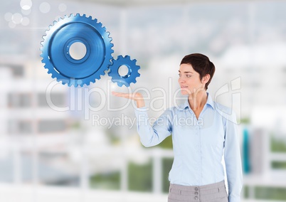 Businesswoman with open hand with cog gears