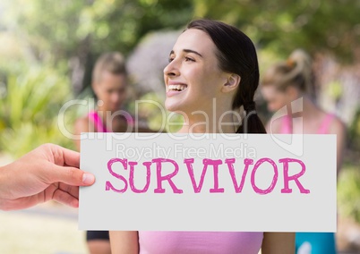 Survivor Text and Hand holding card with pink breast cancer awareness women
