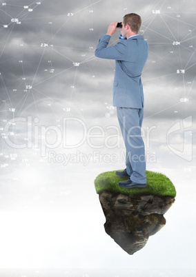 Businessman with binoculars on floating rock platform with interface connecting in sky