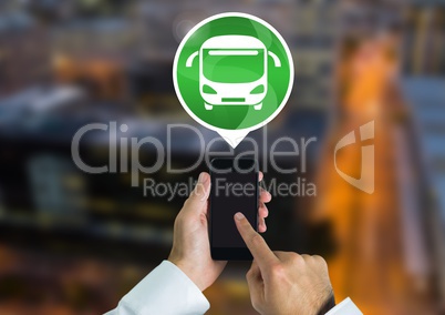 Hand holding phone with bus icon in city