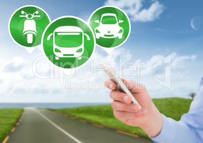 Hand holding phone with transport icons on road
