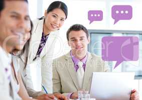 Business people at meeting on laptop with empty chat bubbles