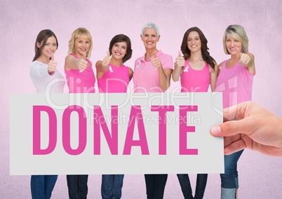 Donate Text and Hand holding card with pink breast cancer awareness women