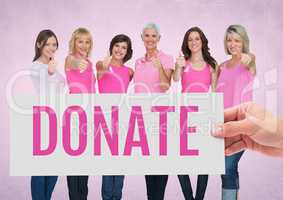 Donate Text and Hand holding card with pink breast cancer awareness women