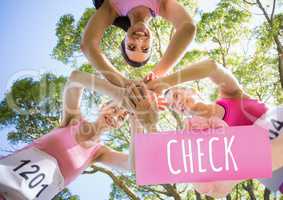 Check Text and Hand holding card with pink breast cancer awareness women marathon run