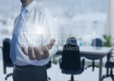 Businessman with open hand in office