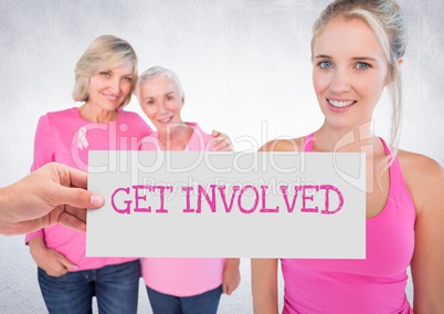 Get Involved Text and Hand holding card with pink breast cancer awareness women