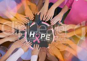 Hope text with breast cancer awareness women putting hands together