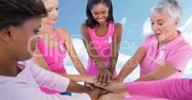 Breast cancer women putting hands together with sky clouds background