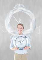 Business woman holding a clock against background with clock