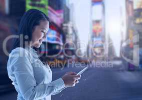 Woman holding phone in city