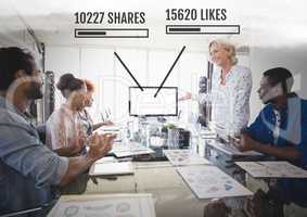 People working in office with Social media interfaces of shares and likes at meeting