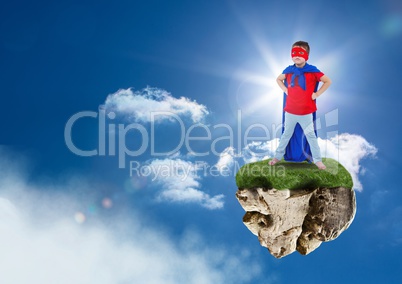 Young superhero boy on floating rock platform  in sky