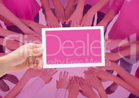 Hand holding card with pink breast cancer awareness women